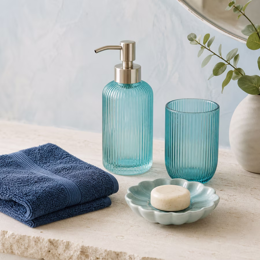 Aqua-blauer Seifenspender und Becher mit Handtuch